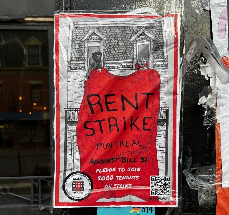 A rent strike poster on a window.