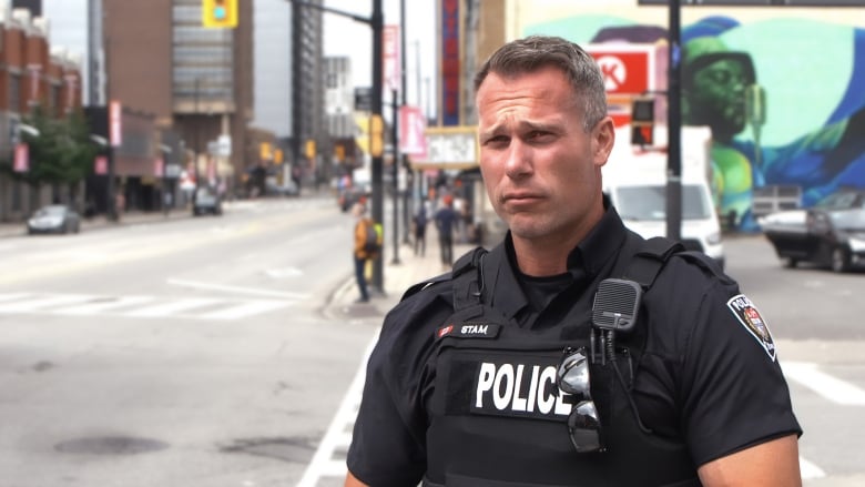 An Ottawa police officer is in the foreground. 