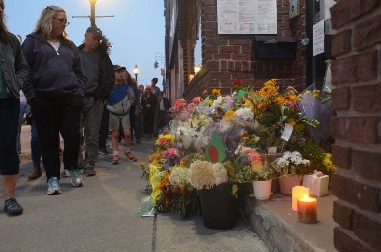 People in Owen Sound pass in front of Sharif Rahman's restaurant Sunday Aug. 28, 2023 following his funeral. Rahman was beaten and later died inside the Curry House. 