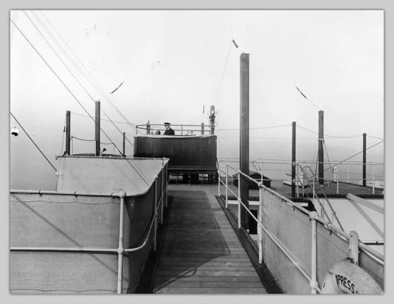 A black and white image of a compass platform located on a ship.