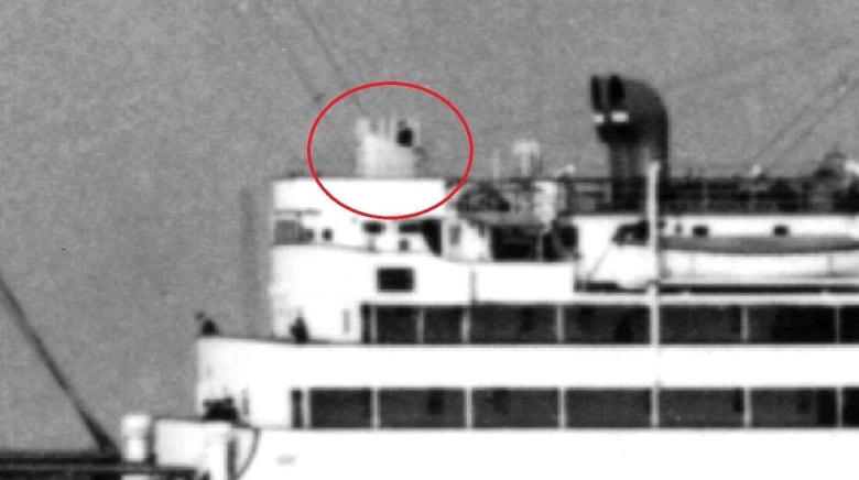 A black and white image of a ship with a red circle pointing to a compass platform located on the deck. 
