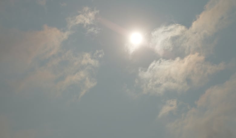 View of the sun in a hazy sky. 
