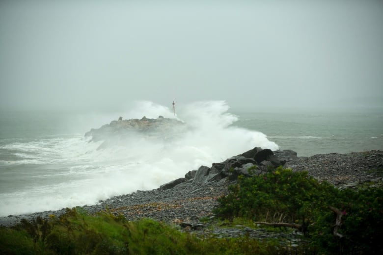 Waves crash against a breakwater in Port Maitland, N.S.
