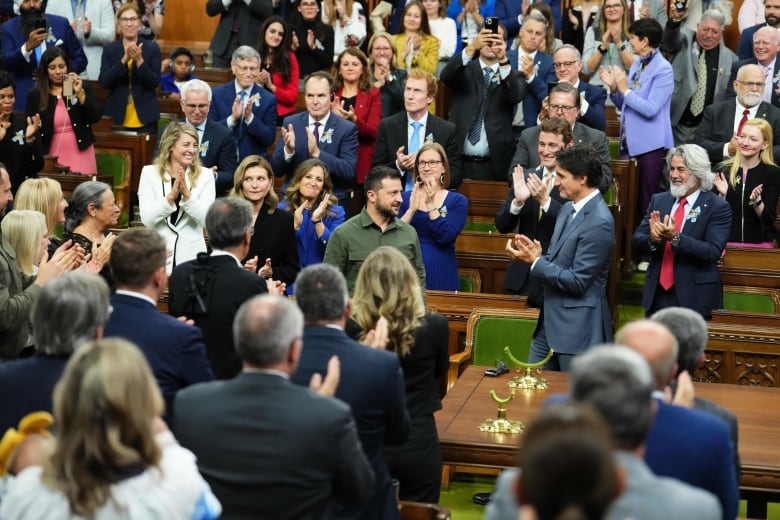 Ukrainian President Volodymyr Zelenskyy receives a standing ovation from Prime Minister Justin Trudeau and parliamentarians as he arrives to deliver a speech in the House of Commons in Ottawa on Friday, Sept. 22, 2023.