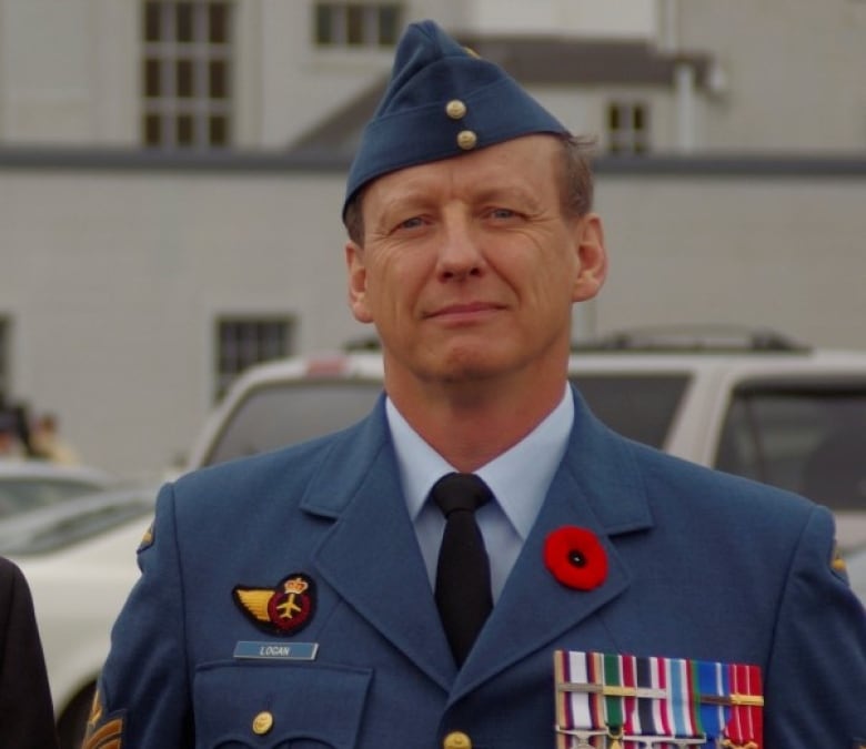 A man in a blue uniform is shown.