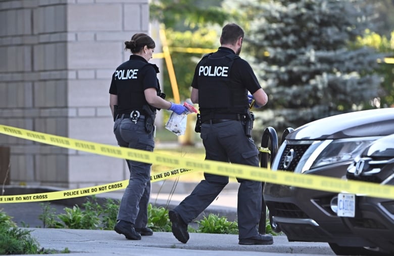 An Ottawa Police officer collects evidence after a Saturday night shooting at the Infinity Convention Centre that left two dead, in Ottawa, on Sunday, Sept. 3, 2023. THE CANADIAN PRESS/Justin Tang
