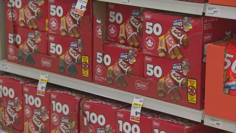 A red box of Nestlé chocolates sits on the shelf. 