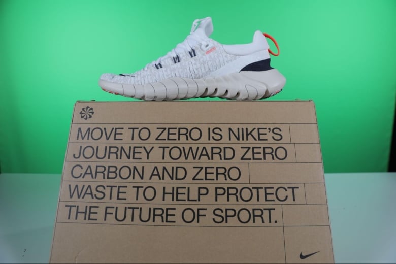 A white sneaker on top of a shoe box that reads "Move to zero is Nike's journey toward zero carbon and zero waste to help protect the future of sport."