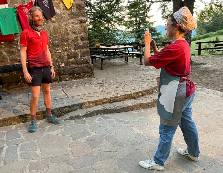 A woman at a Tuscan refuge takes a photo of David Orr. Word travelled among the volunteer workers who run the Great Italian Trail refuges of the 'mad Canadian' running up Italy. 