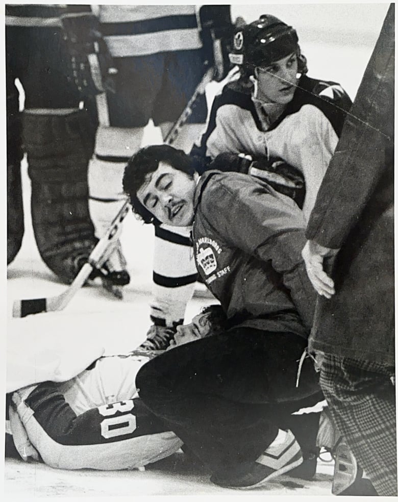 Team trainer Joe Piccininni attends to a gravely wounded Kim Crouch during a Jan. 5, 1975 game in Toronto. Crouch lost a third of his blood after a skate severed his carotid artery. 