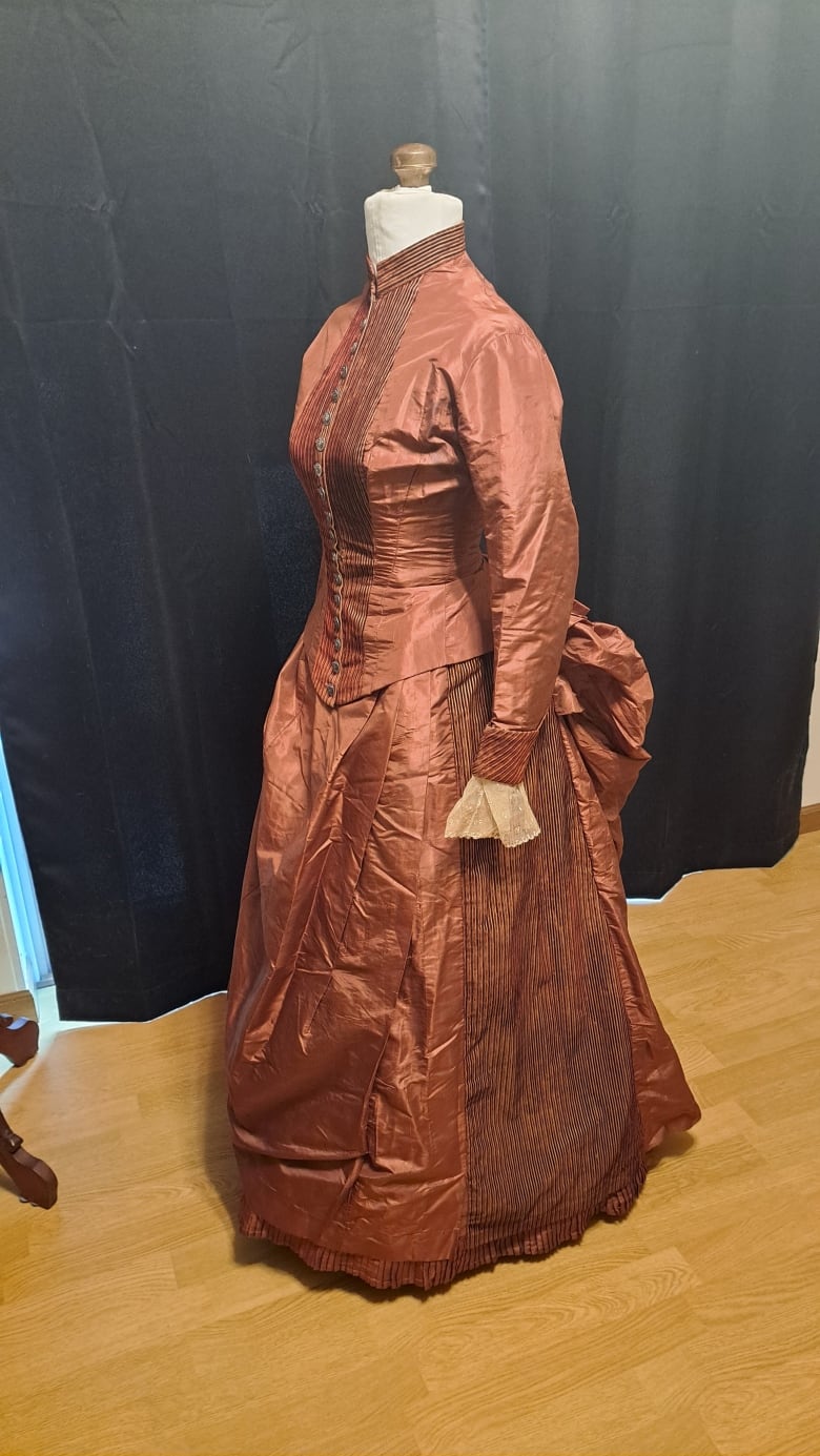 This 1880s-era silk bustle dress has a secret pocket under the skirt, where the two paper sheets containing the Silk Dress cryptograph were found