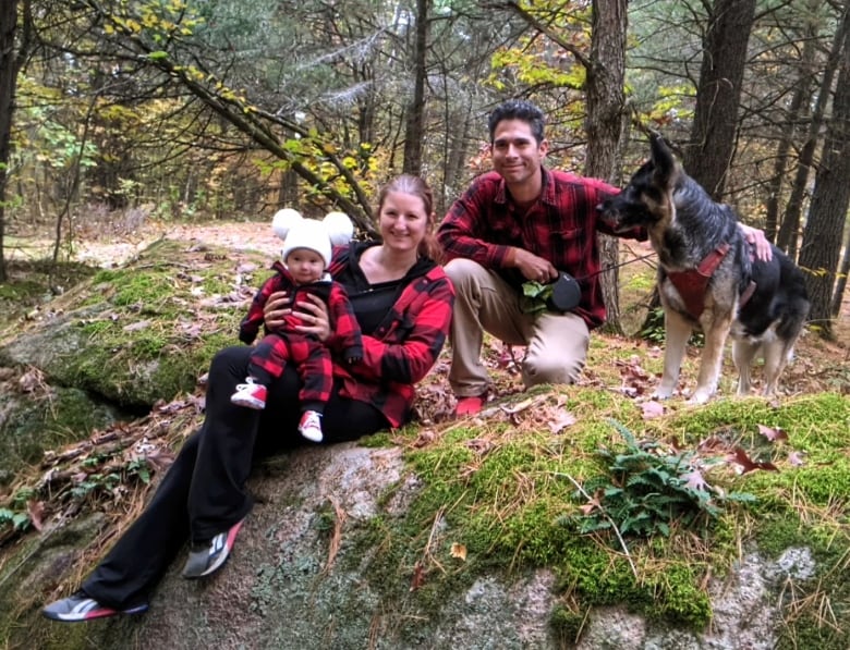 family in plaid shirts on rock