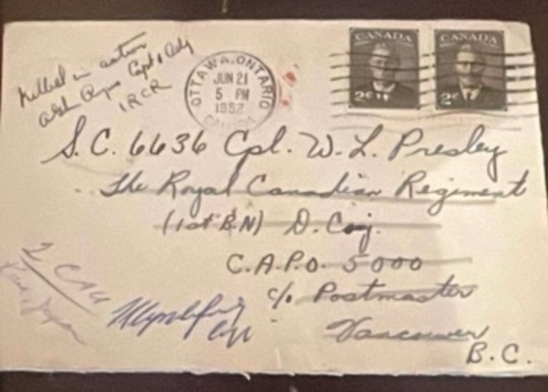 The front of a letter with handwriting and a few stamps. 