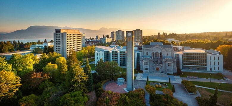 Landscape photo of the University of British Columbia. Views of a tower and several buildings behind it. 