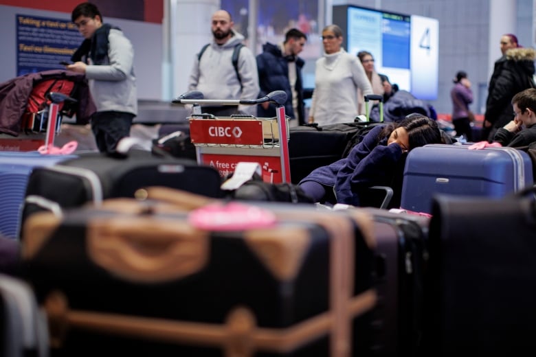 Travellers are pictured at Pearson International Airport, in Toronto, on Dec. 22, 2022 — one of the busiest travel days of the holiday season.
