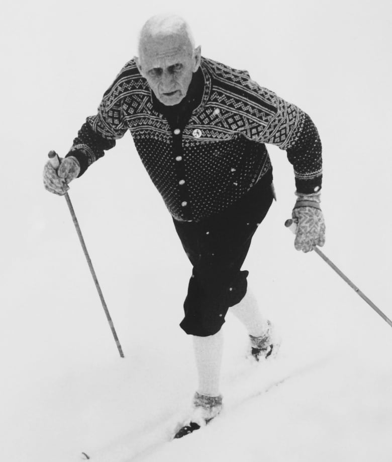 An elderly man on skis