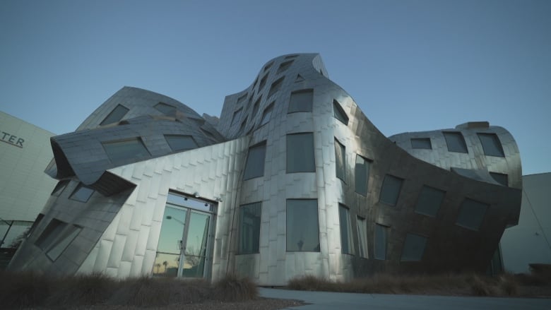 A curved metal building with lots of windows