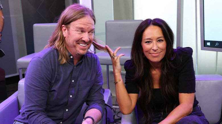 Chip and Joanna Gaines seated in gray chairs