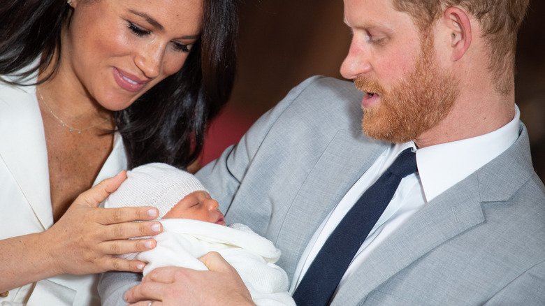 All The Rare Times We've Seen Prince Archie And Princess Lilibet 4 Prince Harry and Meghan Markle looking at Prince Archie