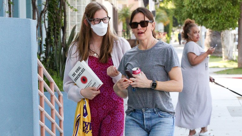 Violet Affleck holds The Viral Underclass during outing with Jennifer Garner