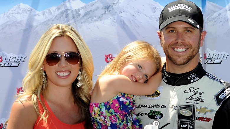 Brian Scott, Whitney Kay, and stepdaughter Brielle posing for the press before a race