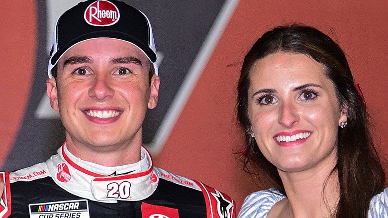 Christopher Bell and Morgan Bell smiling beside one another in Victory Lane