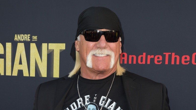 Hulk Hogan smiles while donning an all-black outfit