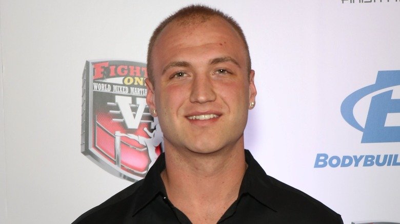 Nick Hogan is all smiles while sporting short dyed hair and a set of earrings.