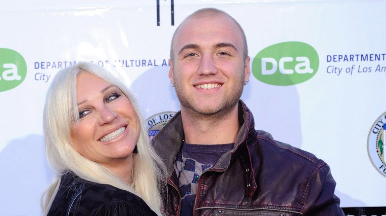 Linda Hogan poses with her arms around Nick in 2009