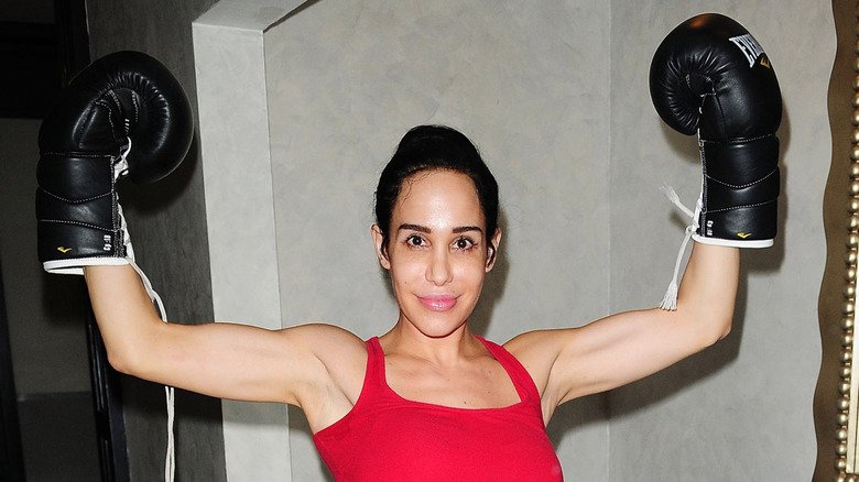 Natalie Suleman posing with a pair of boxing gloves