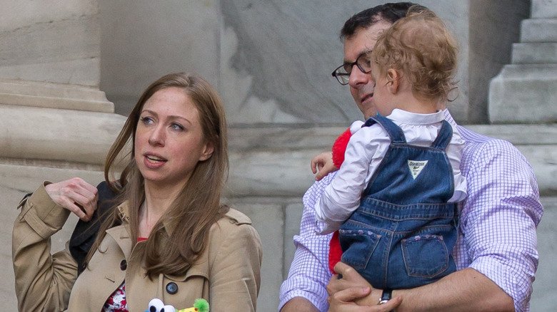 Chelsea Clinton and husband Marc Mezvinsky on walk with daughter Charlotte