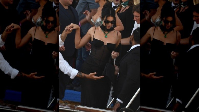 Kendall Jenner wearing a black dress and green jewels at Jeff Bezos and Lauren Sánchez's wedding