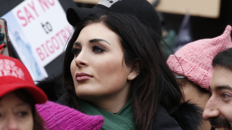 Laura Loomer at a Trump rally with a Women for Trump sign