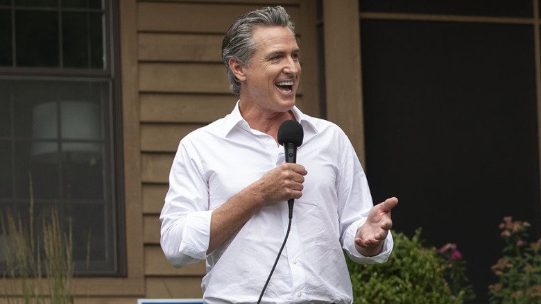Gavin Newsom laughs while making a speech.