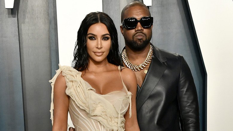 Kim Kardashian and Kanye West posing on the red carpet