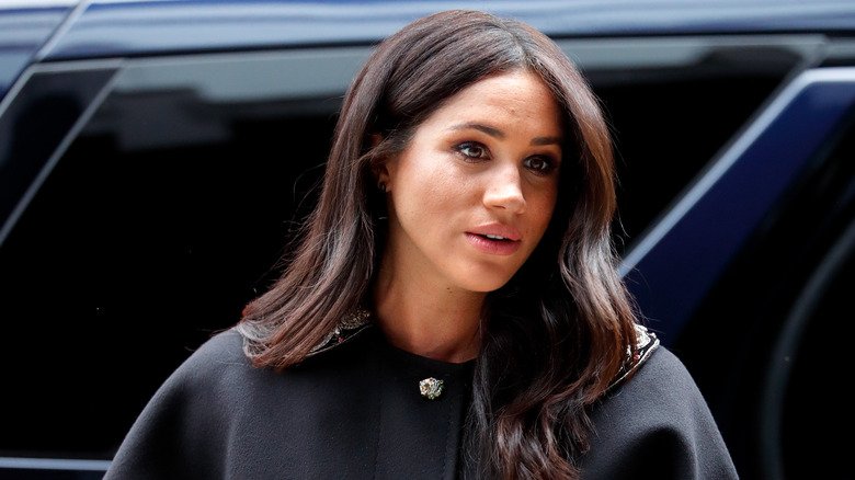 Meghan Markle wearing a black coat