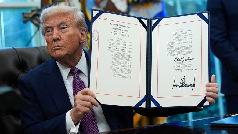 Rumors Trump Couldn't Shake. 129 Donald Trump holding up an executive order with his signature