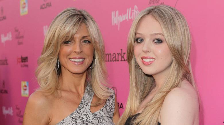 Marla Maples and daughter Tiffany Trump posing in front of a pink background