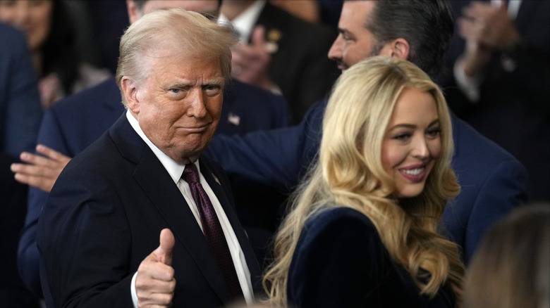 Donald Trump with daughter Tiffany Trump smiling while walking through a crowd