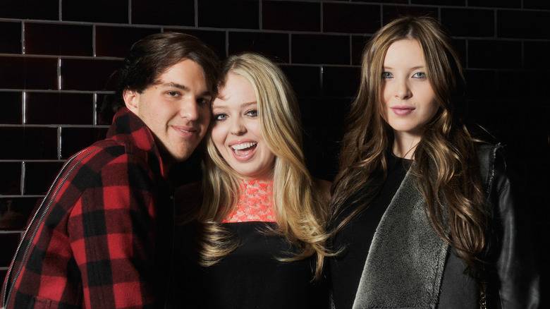 Andrew Warren, Tiffany Trump and unidentified woman smiling while attending party