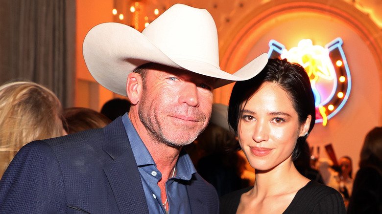 Taylor Sheridan's Yellowstone: The Overlooked Dark Side 5 Taylor Sheridan poses with Kelsey Asbille in 2022