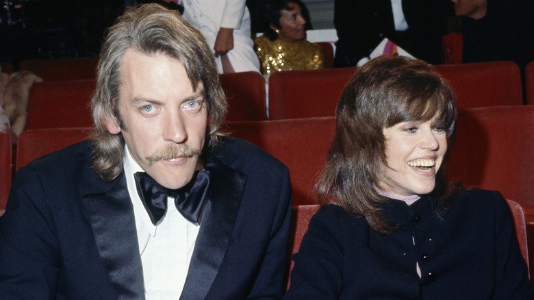 Jane Fonda seated at an award show with Donald Sutherland