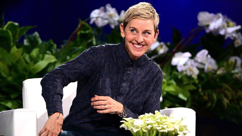 Ellen DeGeneres seated and smiling on her show