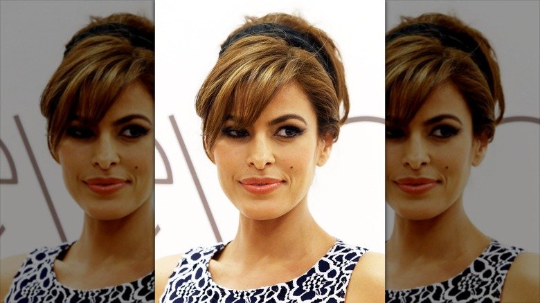 Eva Mendes posing at an event in a black and white dress