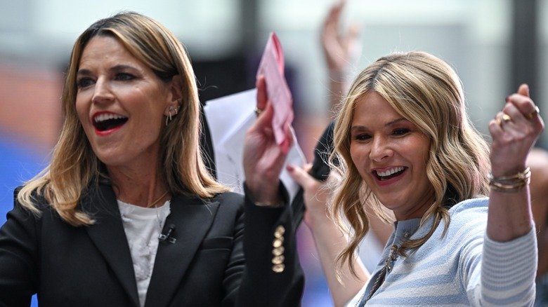 Jenna Bush Hager and Savannah Guthrie cheer looking away from the camera.