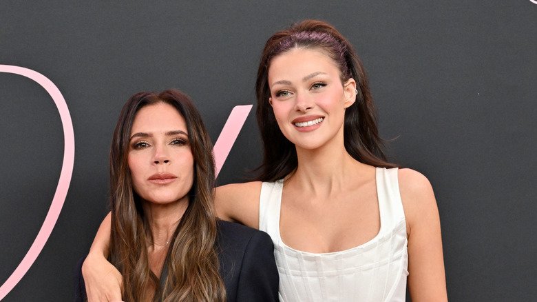 Victoria Beckham and Nicola Peltz posing