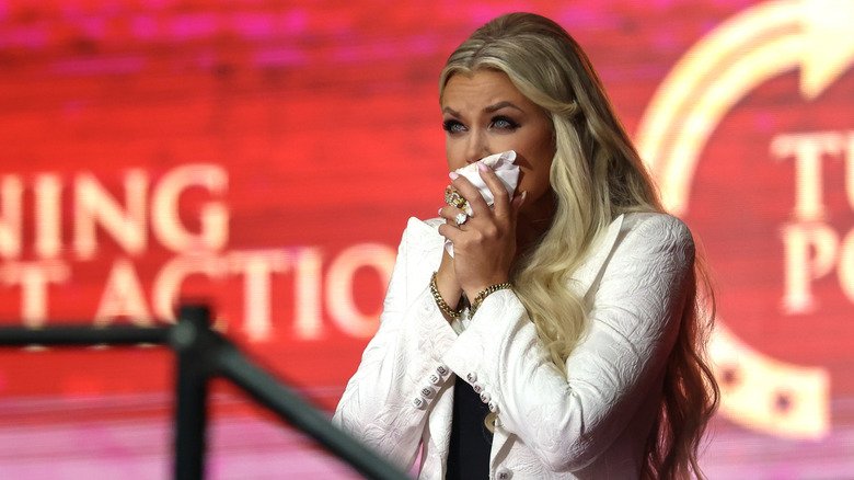 Rumors, Flights, and Old Messages — The Strange Stories Swirling Around Erika Kirk 128 Erika Kirk holding a tissue while she cries onstage in a white suit
