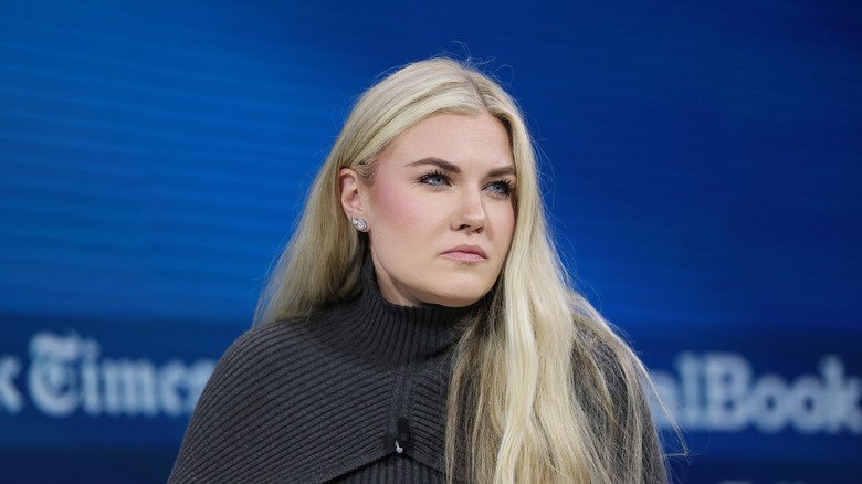 Rumors, Flights, and Old Messages — The Strange Stories Swirling Around Erika Kirk 129 Erika Kirk listening intently during an interview in a dark grey sweater