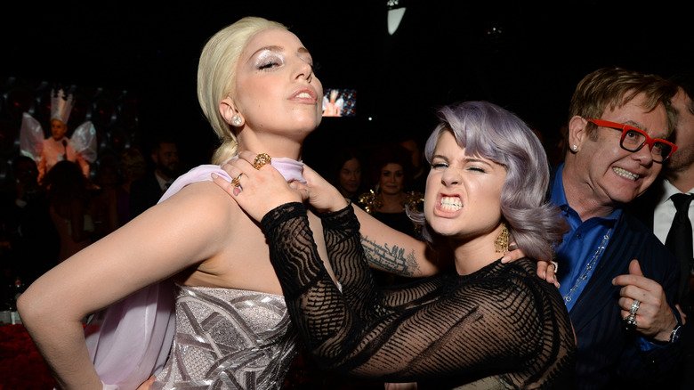 The More Candid Side of Kelly Osbourne 131 Kelly Osbourne playfully choking Lady Gaga while Sir Elton John smiles in the background
