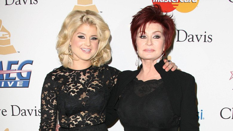 The More Candid Side of Kelly Osbourne 135 Kelly Osbourne in a black sheer lace dress with her arm around Sharon Osbourne in a black high-collared dress